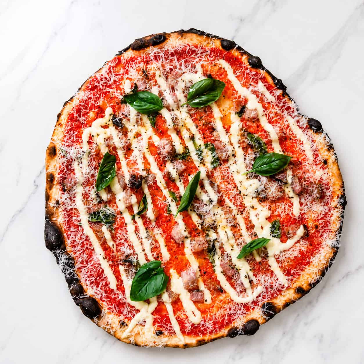Amatriciana Pizza - San Marzano, Guanciale, Pecorino Romano, Basil, Coratina Extra Virgin Olive Oil