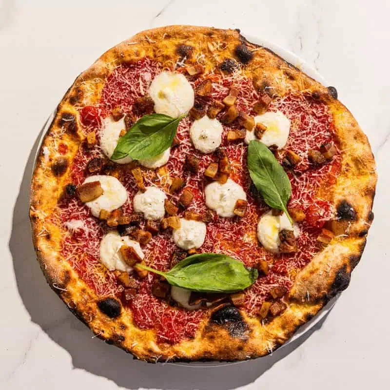 Traditional Amatriciana pizza topped with guanciale, San Marzano pomodoro, and Pecorino Romano cheese