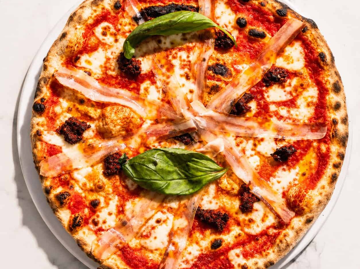 Calabrese Pizza - San Marzano, Buffalo Mozzarella, ‘Nduja, Pancetta, Basil, Coratina Extra Virgin Olive Oil