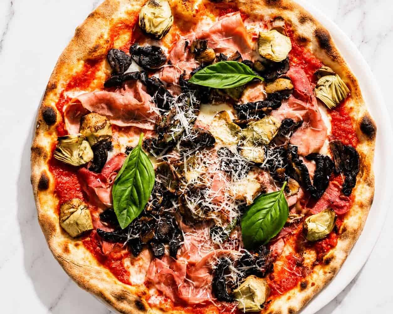 Capricciosa Pizza - San Marzano, Buffalo Mozzarella, Double Smoked Ham, Sautéed Mushrooms, Marinated Artichokes, Basil