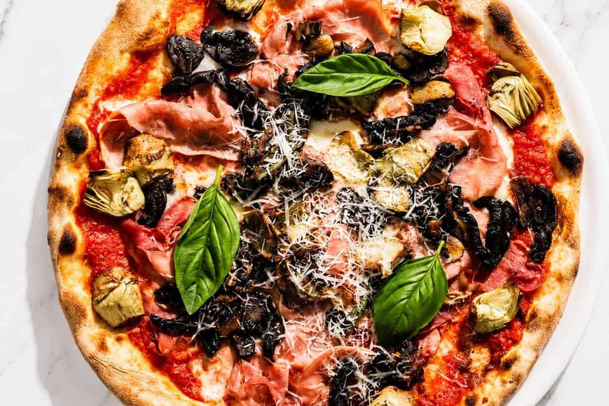 Capricciosa Pizza - San Marzano, Buffalo Mozzarella, Double Smoked Ham, Sautéed Mushrooms, Marinated Artichokes, Basil