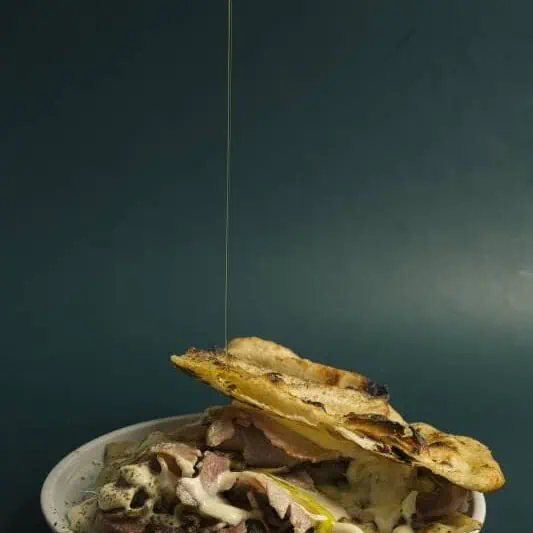 Roman-style croccante bianca with a crispy crust, topped with Porchetta alla Romana and melted provolone cheese