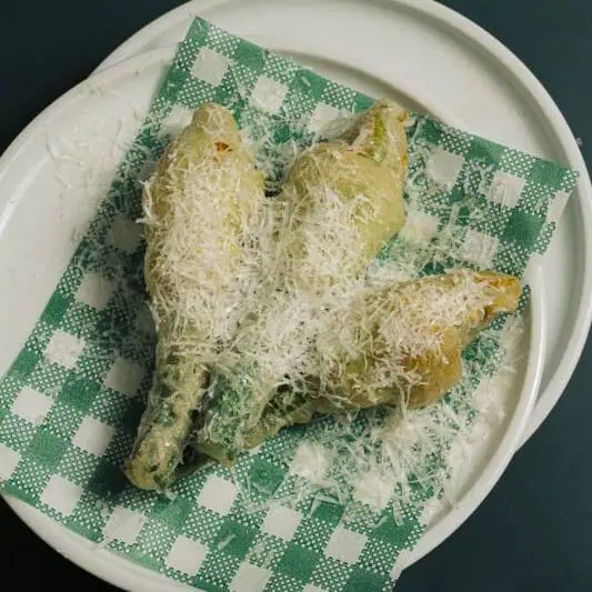 Crispy fried zucchini flowers stuffed with creamy buffalo ricotta, finished with a touch of truffle