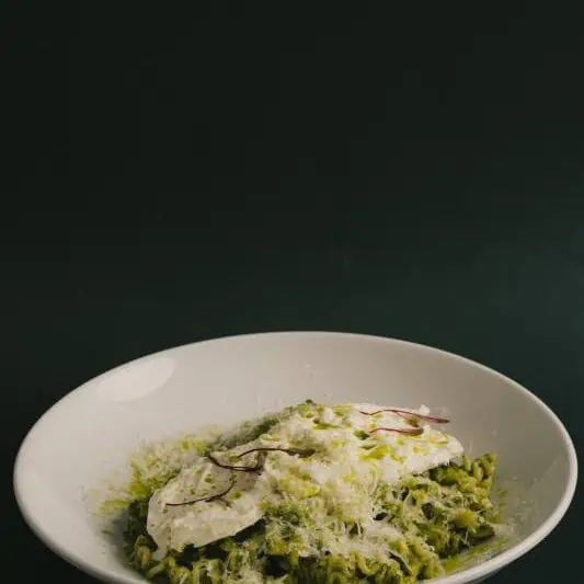 Mafalde pasta tossed in homemade basil pesto, topped with a creamy burrata and finished with extra virgin olive oil