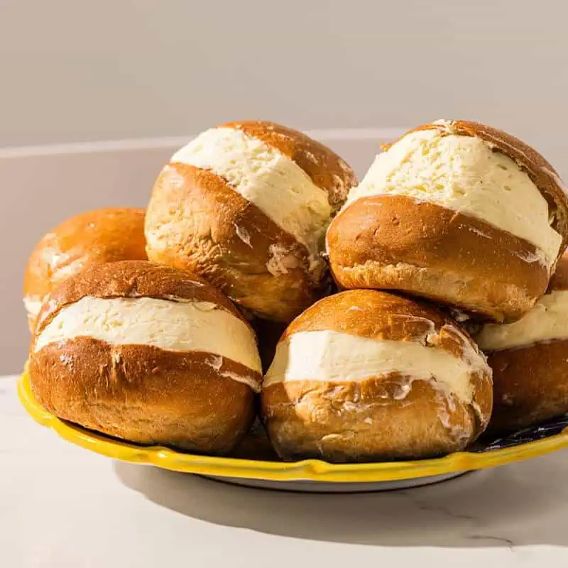 Soft and light Italian maritozzi brioche bun generously filled with sweetened whipped cream, a traditional Roman pastry