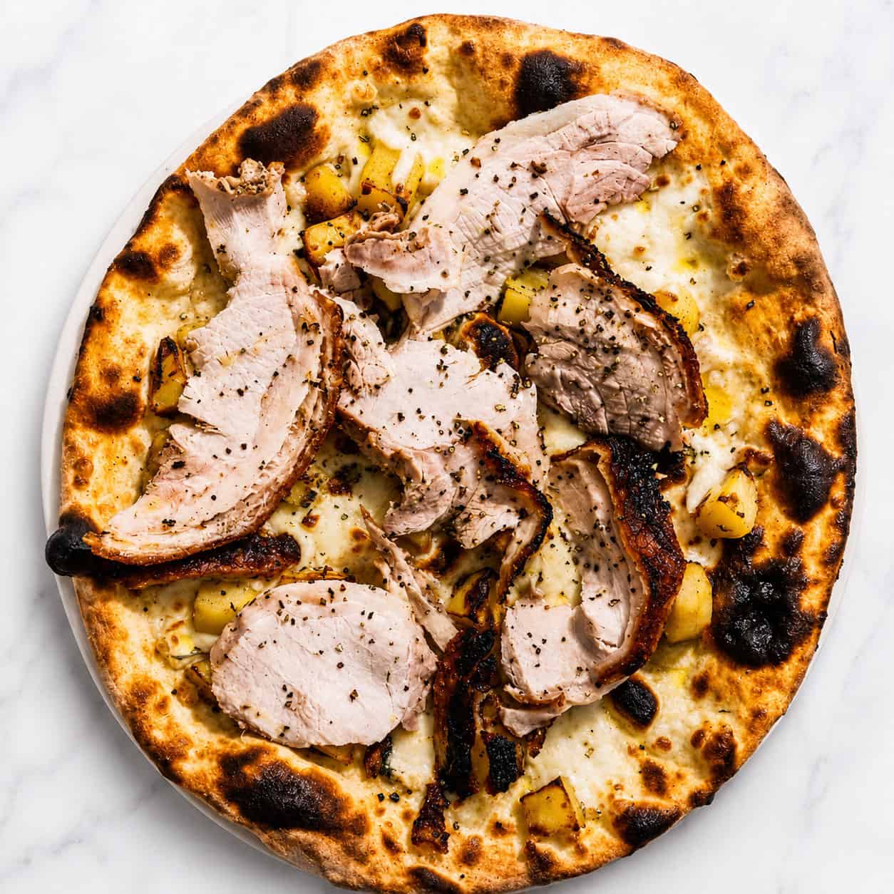 Porchetta di Ariccia Pizza - White Base, Porchetta alla Romana, Wood-Fired Roasted Potatoes, Rosemary, Black Pepper