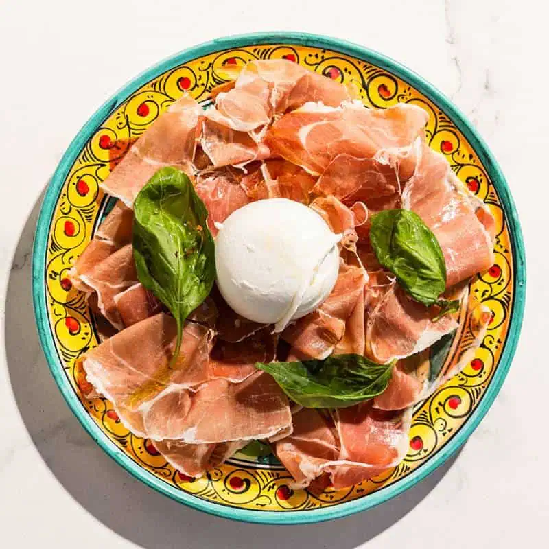 Thinly sliced Prosciutto San Daniele paired with creamy La Stella buffalo burrata, a premium Italian antipasto