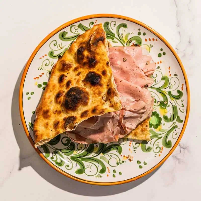 Crispy Roman-style schiacciata bread filled with layers of Italian mortadella – a simple yet iconic street food